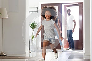 Excited little girl run into own home with young parents