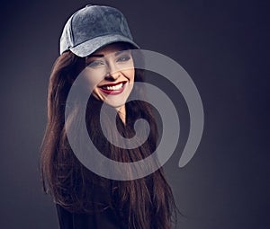 Excited smiling beautiful brunette woman in baseball blue cap wi
