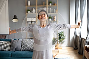 Excited smiling Indian young woman stretching hands, enjoying morning