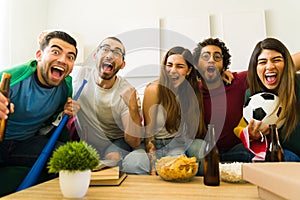 Excited sports fans celebrating their favorite team victory