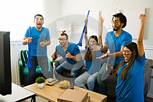 Excited sports fans cheering and celebrating their favorite sports team win