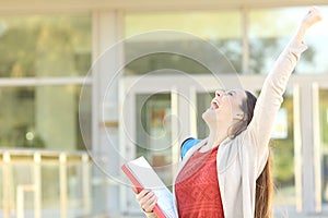 Excited student celebrating good grades in a college photo