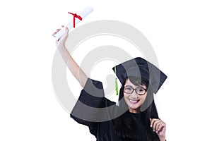 Excited student in graduation gown - isolated