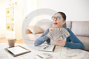 Excited student holding money dollar