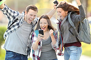 Excited students checking exam grades online photo