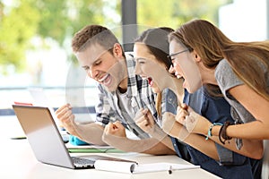 Excited students reading good news in a classroom