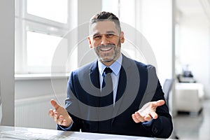 Excited successful middle aged businessman making video call, having virtual online meeting, webcam view