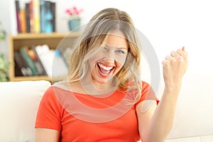 Excited successful woman looking at camera