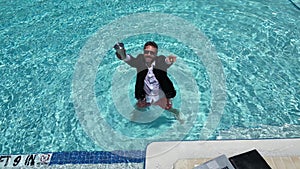 Excited summer business. Funny freelance work. Crazy summer businessman in suit swim in sea pool water. Funny freelancer