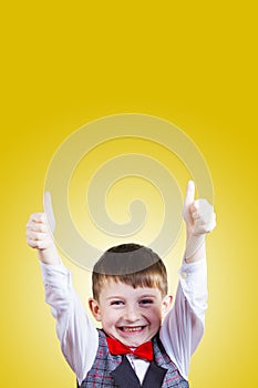 Excited Surprised little boy with thumb up gesture ove