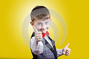 Excited Surprised little boy with thumb up gesture ove