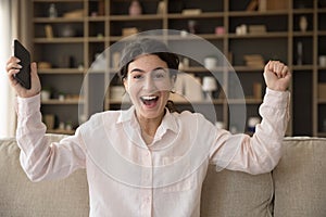 Excited surprised mobile phone user girl receiving happy good news