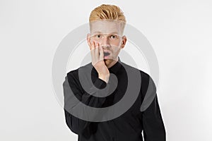 Excited surprised shock young man isolated on gray background. Happy Redhead guy with red beard in black stylish shirt. Success