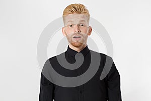 Excited surprised shock young shouting man isolated on gray background. Happy Redhead guy with red beard in black stylish shirt.