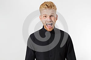 Excited surprised shock young shouting man isolated on gray background. Happy Redhead guy with red beard in black stylish shirt.