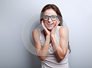 Excited surprising fun young woman with open mouth in glasses