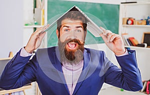 Excited teacher professor with laptop on head wearing formal suit with funny expression emotions funny face.