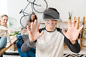 excited teen boy touching something with virtual reality