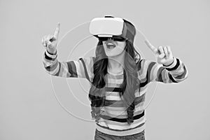 Excited teenager using VR headset. Kid play vr video game. Digital future and innovation. Child in virtual goggles