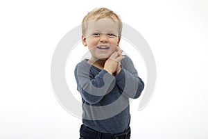 Excited two year old boy looking at something with surprise and joy. studio shot on white background