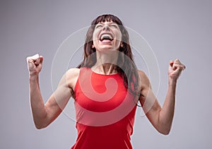 Excited woman celebrating with clenched fists