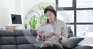 Excited woman celebrating success and reading letter