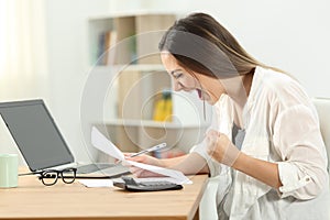 Excited woman checking bank statement photo