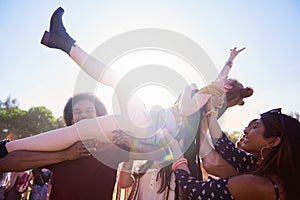 Excited woman crowd surfing at the music festival