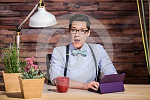 Excited Woman at Desk with Tablet