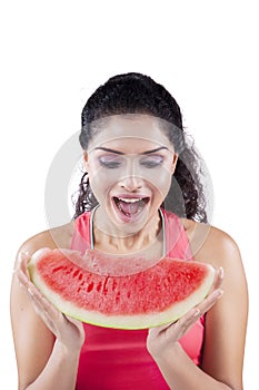 Excited woman eating juicy watermelon