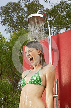 Excited Woman Enjoying Shower At Resort