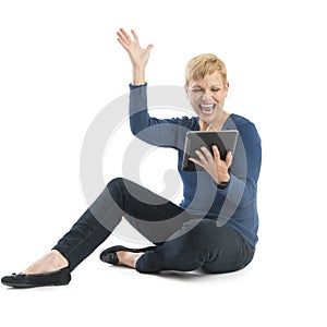 Excited Woman With Hand Raised Looking At Digital Tablet