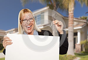 Excited Woman Holding House Keys and Blank Real Estate Sign