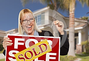 Excited Woman Holding House Keys and Sold Real Estate Sign