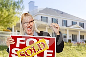 Excited Woman Holding House Keys and Sold Real Estate Sign