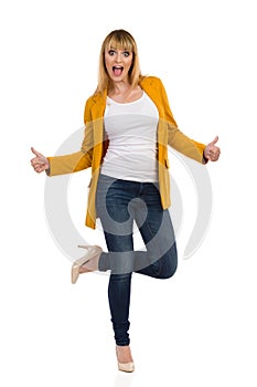 Excited Woman IsStanding On One Leg Shouting And Showing Thumbs Up