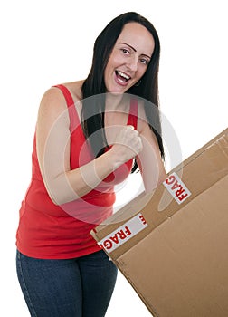 Excited woman opening a parcel