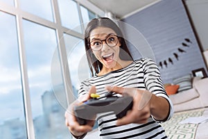 Excited woman playing virtual games using a game console