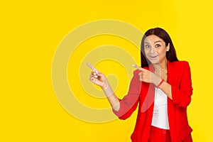Excited woman pointing with index fingers to the side