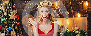 Excited woman portrait over Christmas background. Beauty makeup and retro hairstyle for Christmas or new year party. New