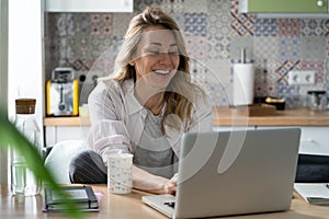 Excited woman read job offer email from successful company on covid-19 lockdown at home on laptop