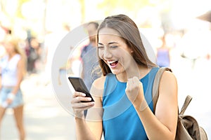Excited woman reading amazing news on line