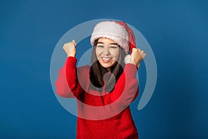excited woman rejoices in christmas sale clenches fists have good mood feel happy excited emotion on blue background,