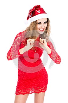 Excited woman in Santa hat with clenched fists