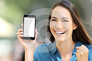 Excited woman showing a blank phone screen