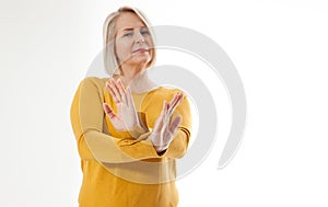 Excited woman showing the sign of stop, neglect, negation and reluctance