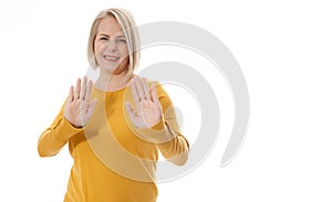 Excited woman showing the sign of stop, neglect, negation and reluctance photo