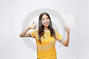 Excited woman thumbs up with blank poster sign. Young woman mixed asian caucasian ethnicity.