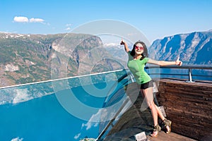 Excited woman tourist at Stegastein Viewpoint