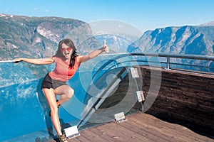 Excited woman tourist at Stegastein Viewpoint